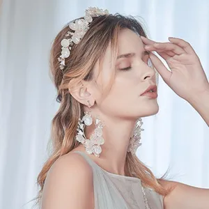 Bridal handmade floral hair band with matching earrings, elegant wedding accessory.