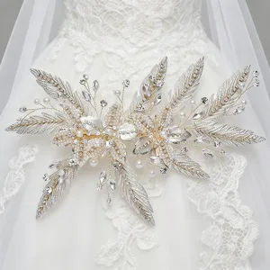 Exquisite rhinestone pearl leaf bridal hair clip detail, perfect for wedding dress styling.