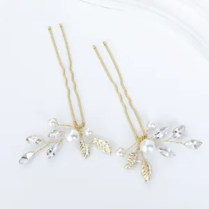Gold bridal hairpins with faux pearls and crystals, elegant wedding hair accessories details.