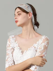 Exquisite details of the French style bridal veil headband and lace dress accessory.