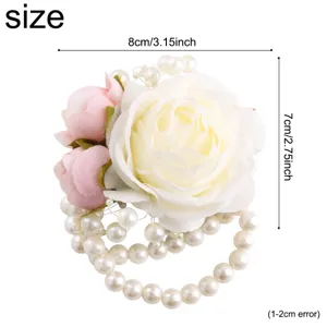 Elegant wedding wrist flower with white pink roses and pearl bracelet for bridal party.