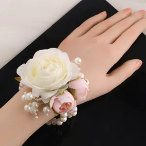Elegant artificial rose wrist corsage with pearls for wedding bridesmaid bridal detail.
