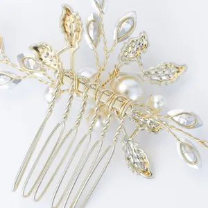 Bridal hair comb detail, gold metallic leaves, faux pearls and sparkling crystals.