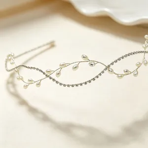 Detailed close-up of handmade bridal rhinestone and pearl hairband, elegant wedding hair accessory.