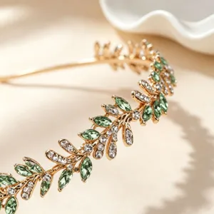 Detailed view of a vintage gold leaf rhinestone headband, elegant bridal hair accessory for weddings.