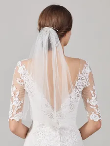 French bridal veil with lace wedding dress, handmade fabric hair accessory for elegant wedding look.