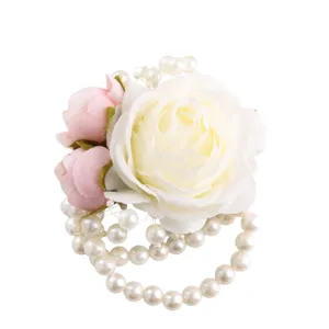 Wedding bridal wrist corsage with white rose and artificial pearls for bridesmaids.