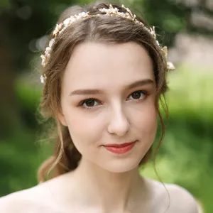 Gold bridal leaf headband with pearls, elegant hair accessory for wedding and party styling.