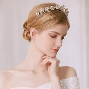 Detailed close-up shot of the elegant bridal rhinestone tiara and floral headpiece in use.