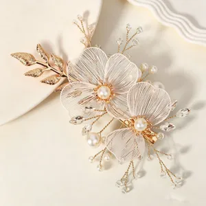 Exquisite bridal hair clip detail featuring gold wire flowers, pearls and crystal beads.