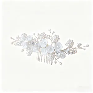 Bridal pearl hair comb, elegant white floral hair accessory for wedding hair styling details.