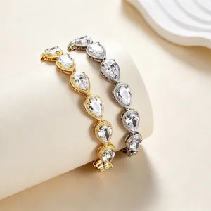 Stunning teardrop zircon tennis bracelet detail, sparkling crystal stones with dual-tone finish.