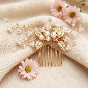 Close-up detail of the elegant wedding hair comb featuring golden leaves and pearls.