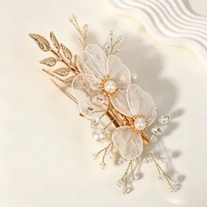 Korean bridal hair clip with gold leaves, mesh petals and pearls for wedding styling.
