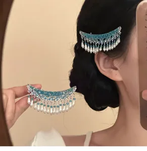 Traditional Chinese style crescent hair clip with pearls and blue tassels for Hanfu styling.