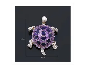 Detailed view of a purple crystal rhinestone turtle brooch, featuring fine metal and sparkling stones.