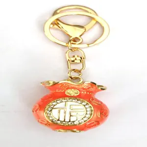 Metal red rhinestone lucky bag keychain pendant detail, elegant gold ring and clasp design.