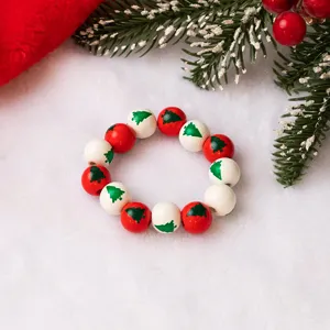 Christmas wooden bead bracelet with cute tree pattern red and white holiday jewelry gift.