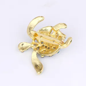 Detailed close-up view of the secure safety pin back mechanism on the sparkling crystal turtle brooch.
