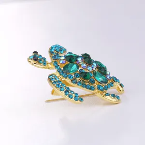 Exquisite turtle brooch featuring sparkling blue and green rhinestones in a gold-tone alloy setting.