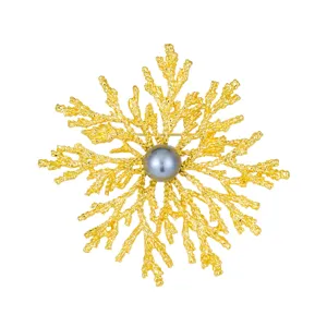 Elegant gold-tone coral branch brooch featuring a dark grey pearl centerpiece for coat decor.