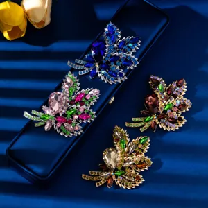 Exquisite crystal leaf brooch detail, shining rhinestone floral clothing accessory.
