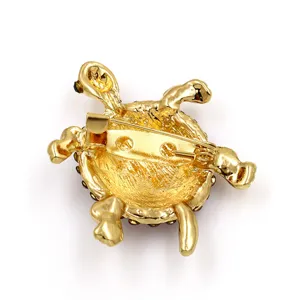 Gold crystal turtle brooch pin back view, elegant animal fashion clothing accessory item.
