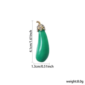 Close-up detail of green eggplant enamel brooch featuring gold rhinestone cap and glossy finish.
