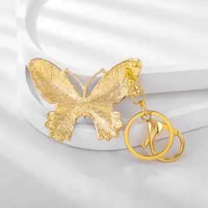 Golden metal butterfly keychain detailed view, chic insect key chain pendant accessory.