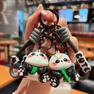 Cute panda keychain detail, dual cartoon panda figures with bamboo and strap pendant decor.