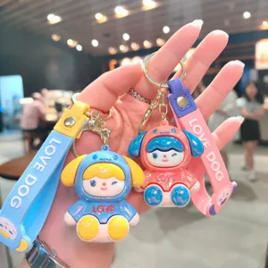 Close-up of cute electroplated cartoon dog keychains with colorful straps and key rings.