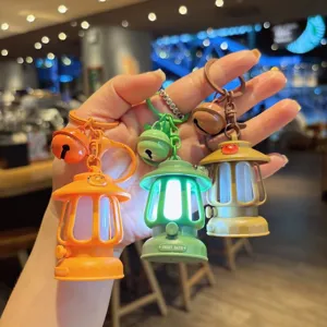 Mini camping lantern keychain detail view, glowing novelty key ring bag pendant accessory