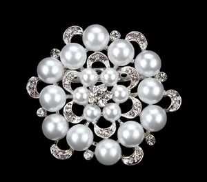 Detailed view of the elegant pearl rhinestone brooch, showcasing sparkling crystal details.