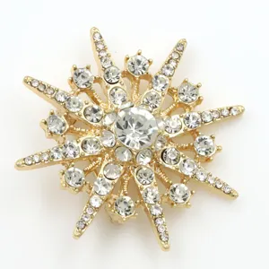 Gold-tone eight-pointed star brooch sparkling crystal rhinestone pin apparel accessory.