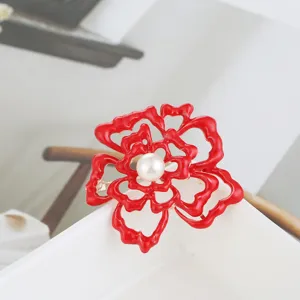 Red oil drop flower brooch detail view, metal pearl corsage pin for women clothing accessories.