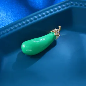 Chic green enamel eggplant brooch with rhinestone details, perfect clothing accessory.