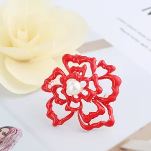 Red camellia brooch pin with pearl center elegant floral clothing accessory for women.