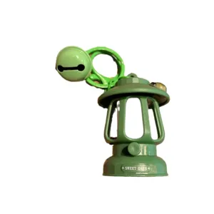Mini green camping lantern keychain with cute cartoon bell pendant, bag charm accessory gift.