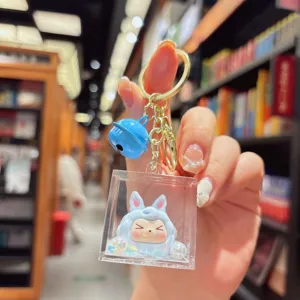 Grazioso portachiavi in acrilico sabbie mobili con ciondolo mostro blu, ideale per borse e regalo.