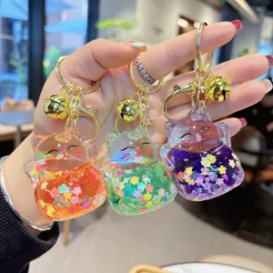 Cute acrylic lucky cat keychains with liquid quicksand, glitter sequins, and gold bells.