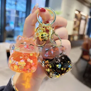 Acrylic liquid floating sand lucky cat keychain charm for backpack and car keys aesthetic.