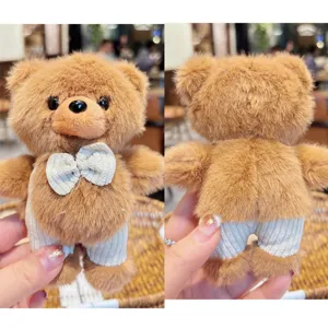 Cute fluffy brown bear keychain plush doll with bow tie and pants detail display