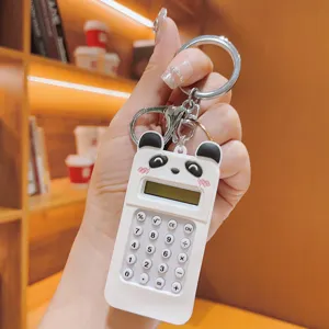 Detailed close-up of a cute panda mini calculator keychain, portable backpack pendant in white.