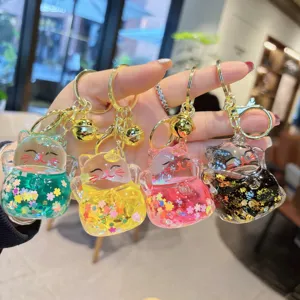 Cute liquid quicksand lucky cat keychain, transparent acrylic bag pendant with bells for car.