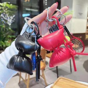 PU leather bow keychain with mini tennis racket pendant, stylish bag charm accessory.