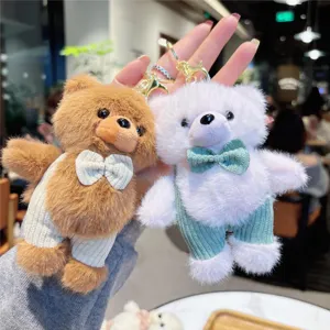 Close-up of fluffy bear keychains with cute overalls and bow ties, detailed plush pendant.