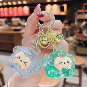 Detailed view of the cute quicksand glitter dumpling keychain with shiny sequins and bells.
