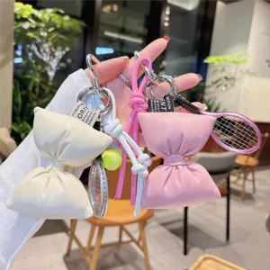 PU leather bow keychain with tennis racket charm, stylish bag pendant and key ring accessory.