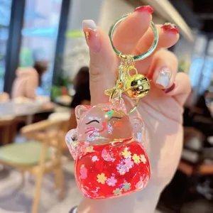 Acrylic liquid quicksand lucky cat keychain detail, sparkling bag charm with cute bell.