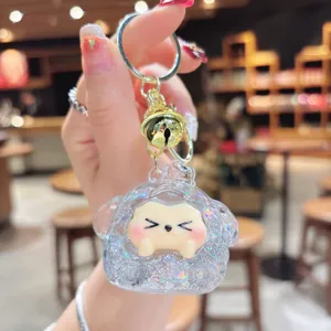 Cute quicksand glitter dumpling keychain detail, lovely trendy toy pendant with golden bell.